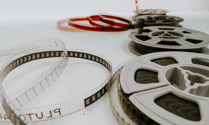 Film reels and unwound film strips laid out on a surface — video and photo production studio case study